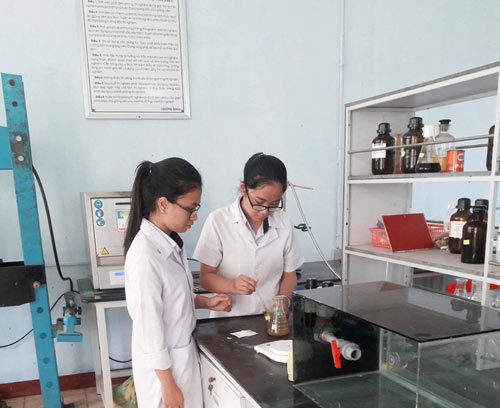 Hai em đang nghiên cứu trong phòng thí nghiệm. Ảnh: Nhật Tuấn.